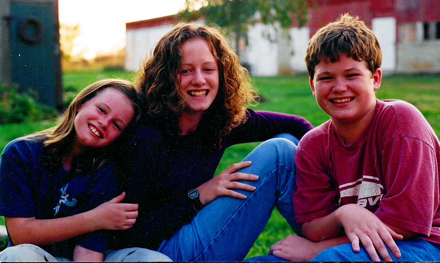 a picture of three children smiling