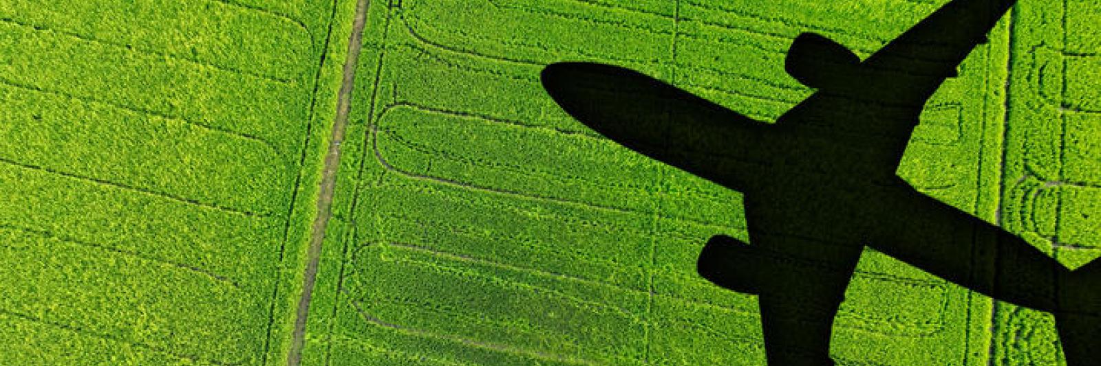 stock image of a shadow of an airplane over a field