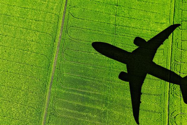 stock image of a shadow of an airplane over a field